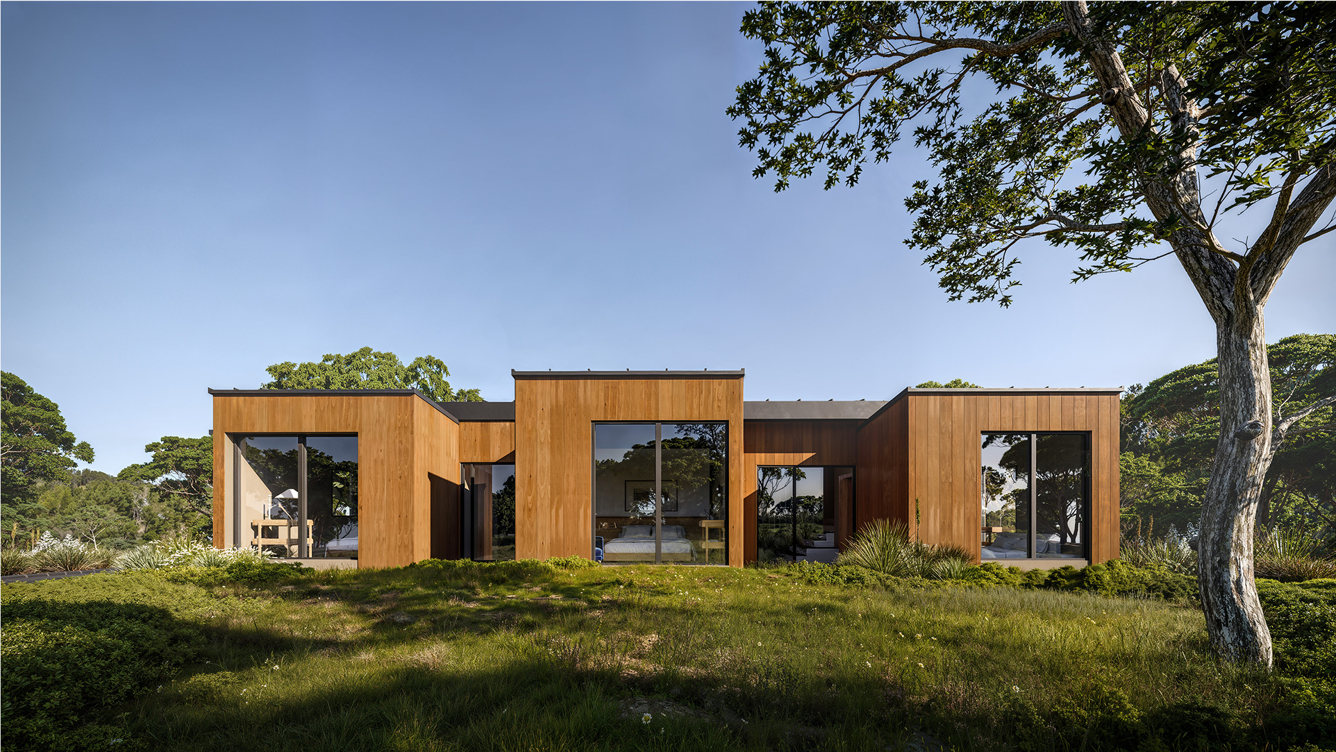 Modern, wood-clad Chalk Hill home showcasing expansive windows and serene landscaping.