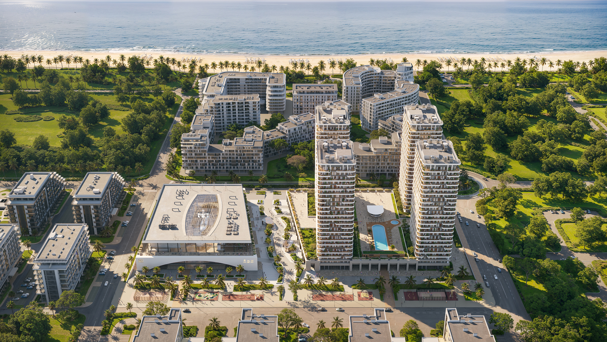 Aerial view of Sky Park Apartments complex, showcasing multiple residential buildings, lush landscaping, and a beachfront location.