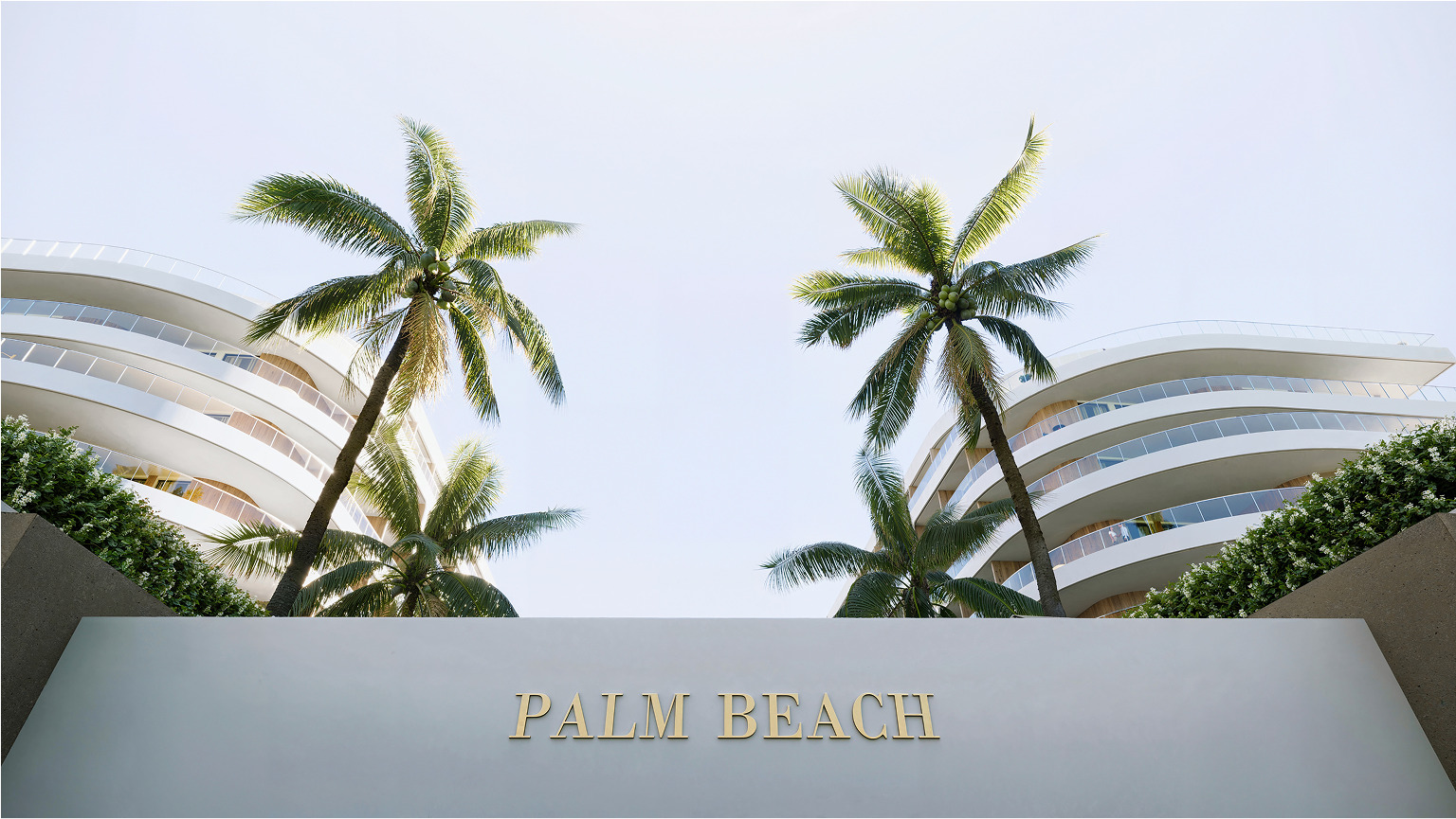 Palm Beach luxury building entrance with palm trees and 