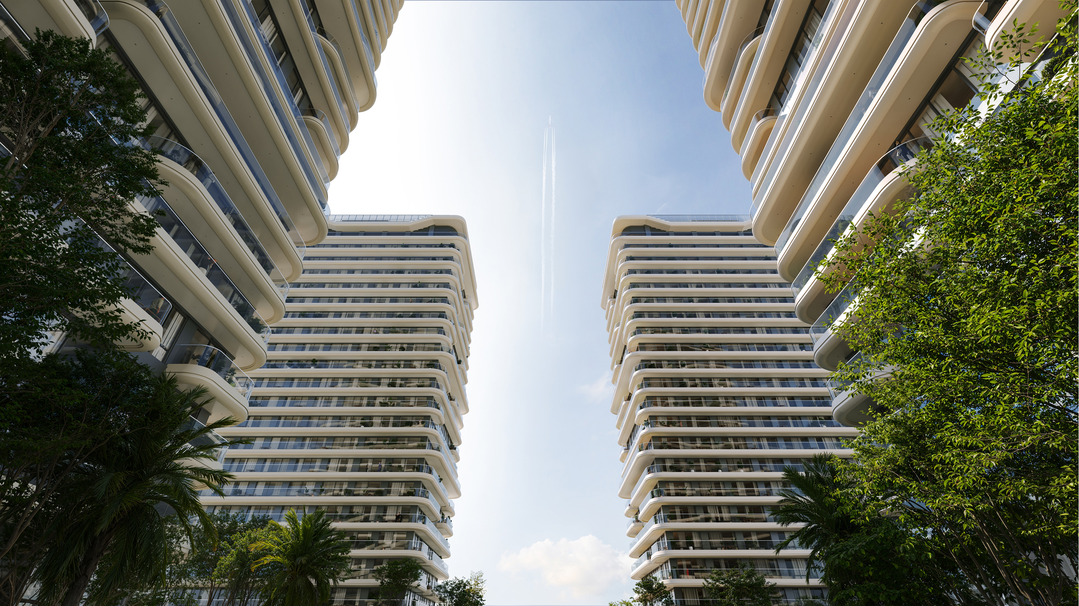Two modern Sky Park apartment buildings with curved balconies, seen from below against a blue sky.