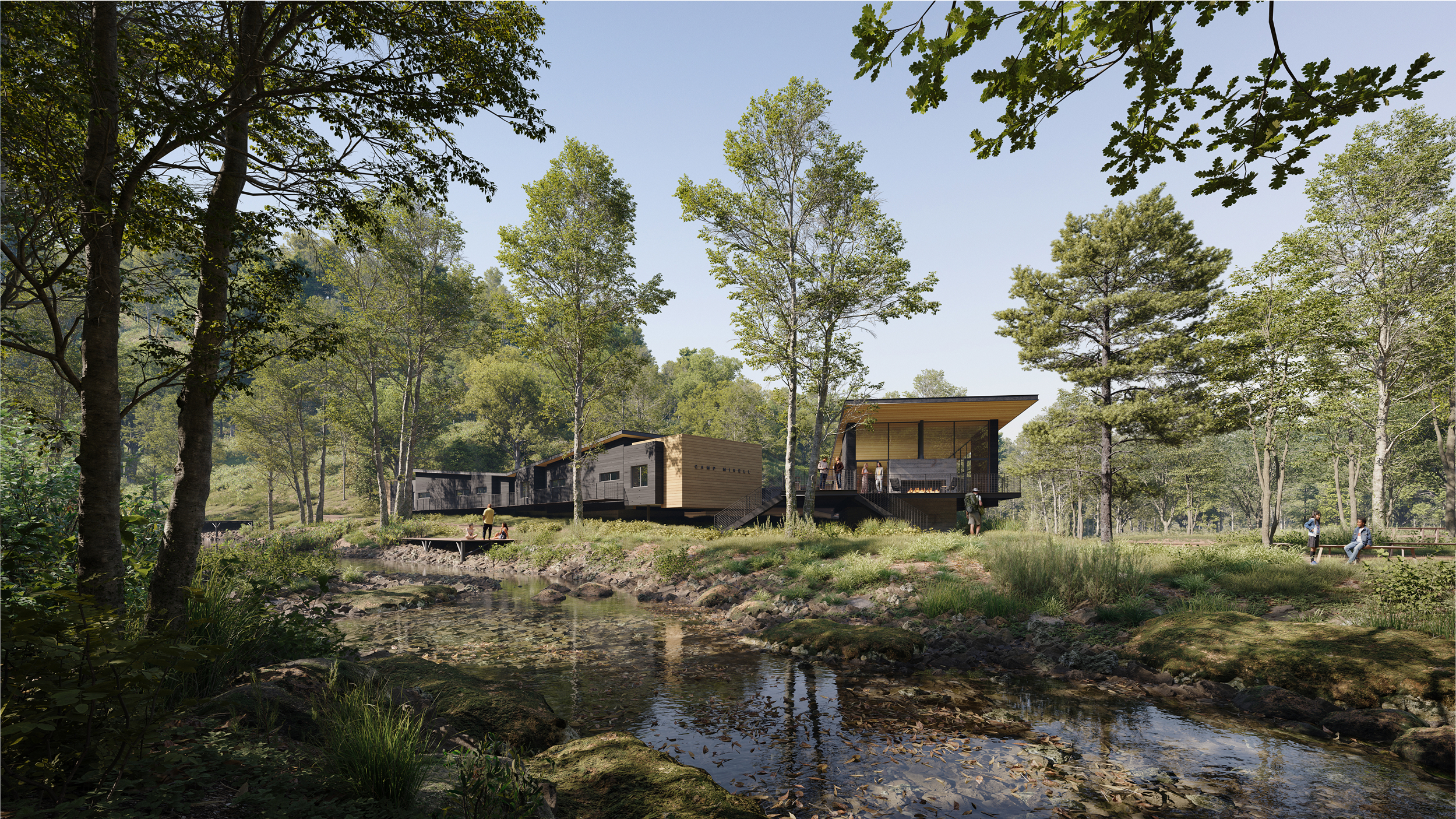 Wooden cabins among trees at Camp Mikell near a small stream