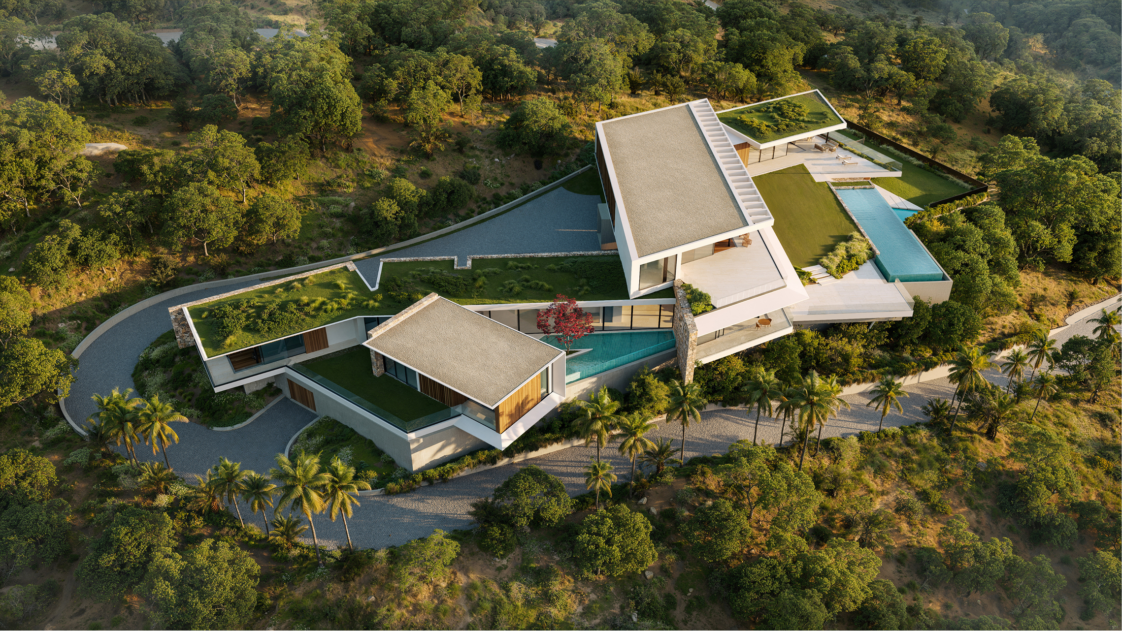 Aerial view of a modern, multi-level home nestled in lush greenery. The home features a pool and green roofs.