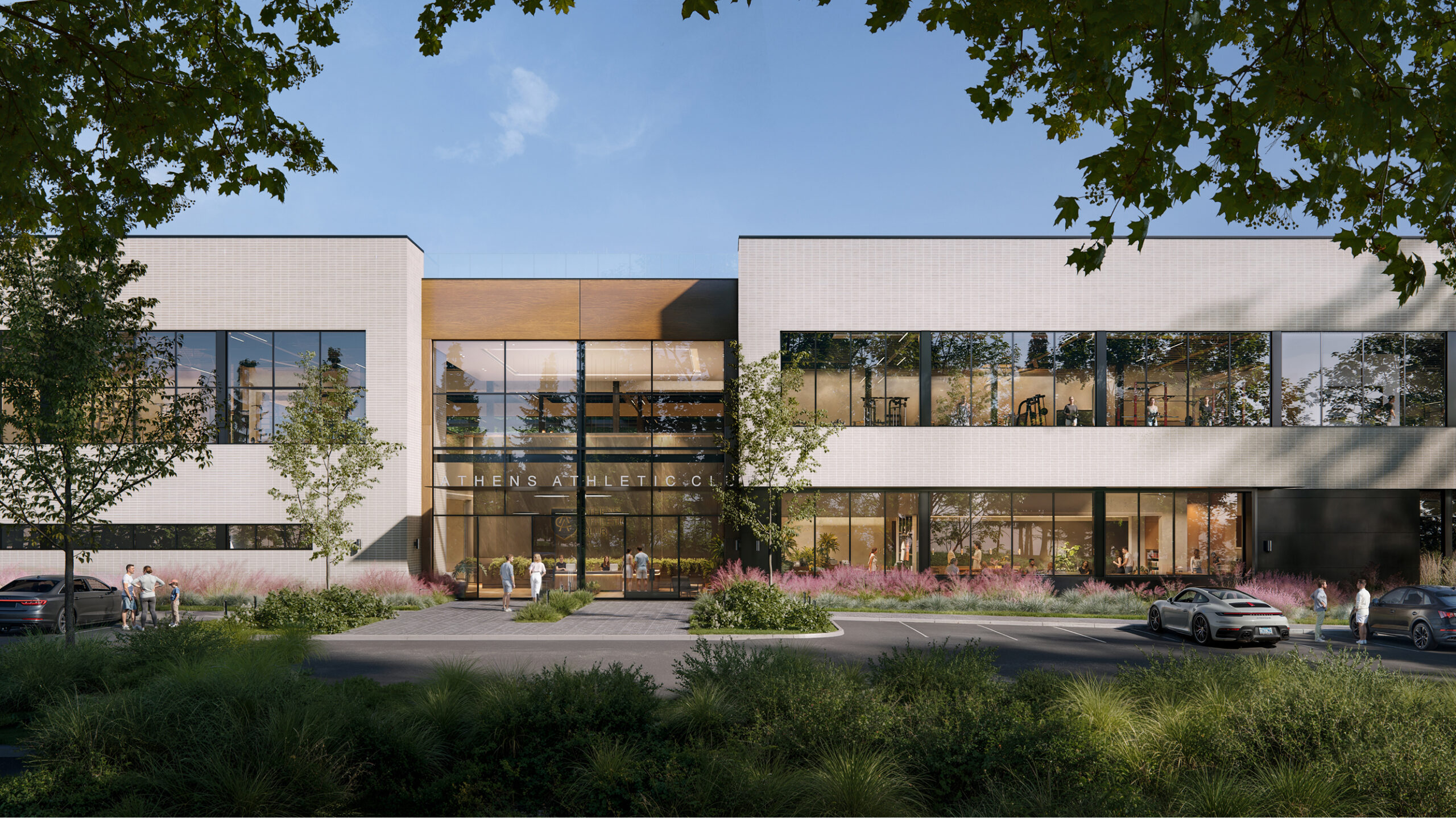 Athens Athletic Club exterior: modern building with large windows, showcasing fitness equipment and people inside.