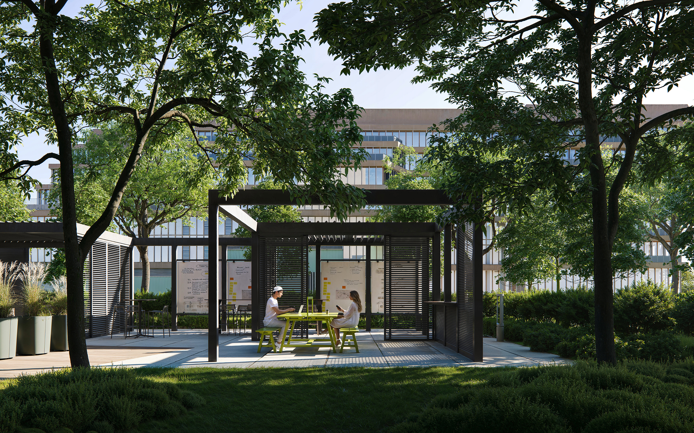 Modern outdoor seating area with pergola and surrounding greenery