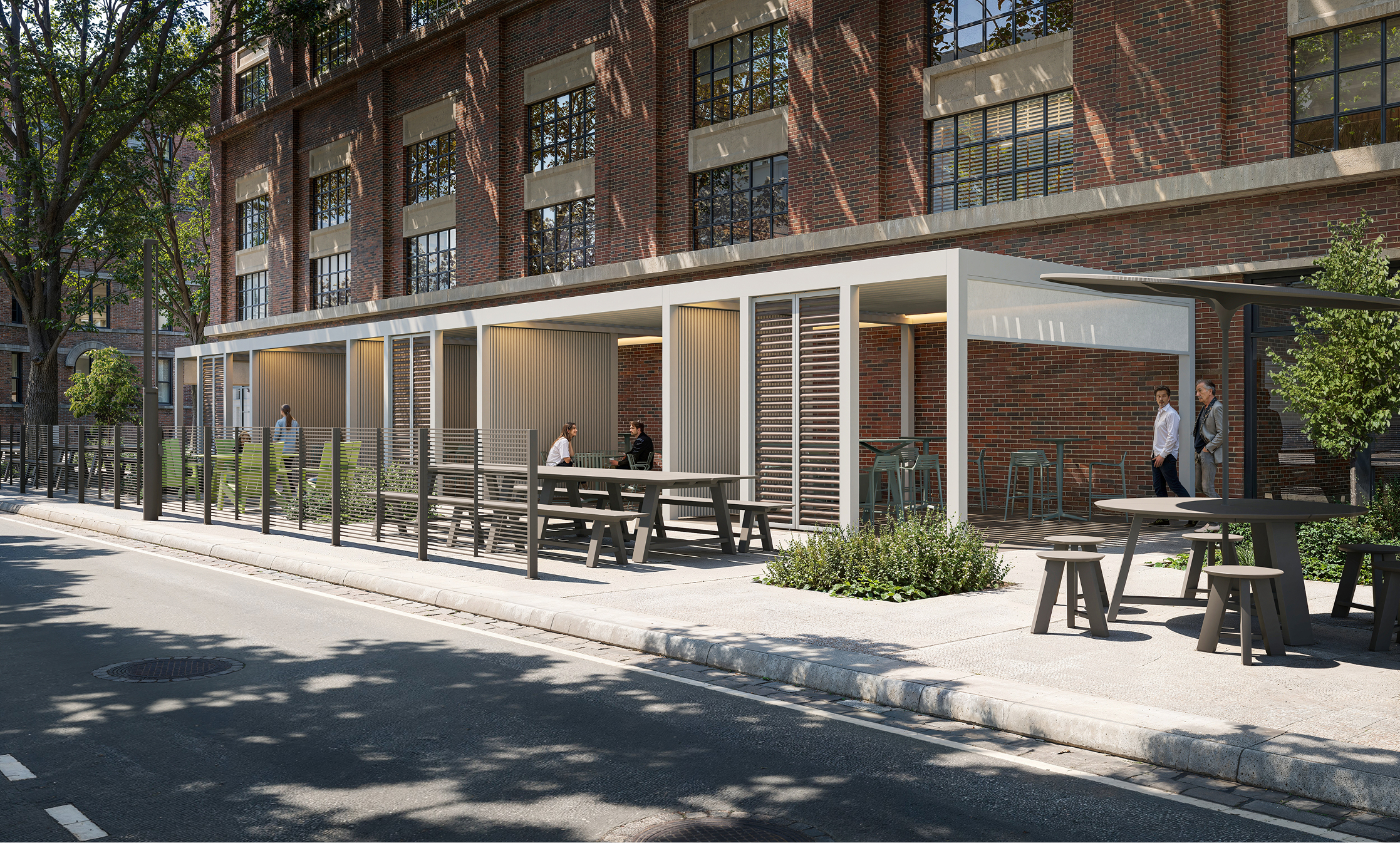 Modern outdoor seating area with Landscapeforms furniture near a brick building.